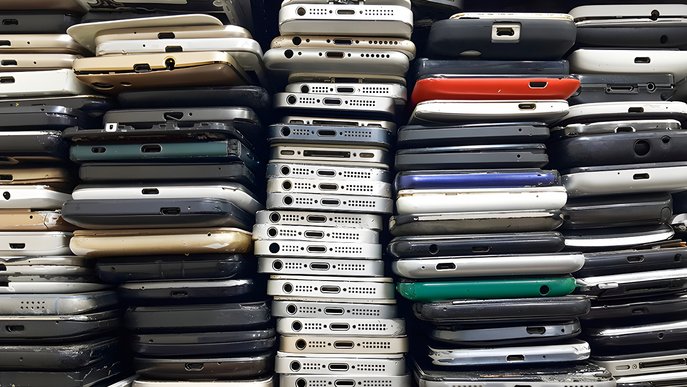 Bild zeigt Stapel von alten Smartphones. Es geht um die Wiederverwendbarkeit von Elektrogeräten. 