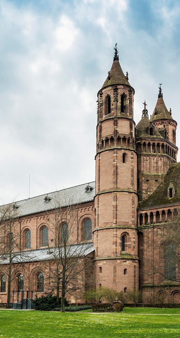 Wormser Dom mit imposanten Türmen, umgeben von Bäumen. ENTEGA als klimafreundlicher Ökostromanbieter in Worms.