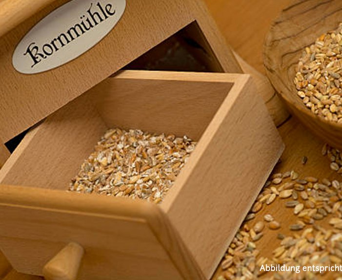 Kornmühle aus Holz, Schublade mit frisch gemahlenem Schrot, Holzschale mit Körnern.
